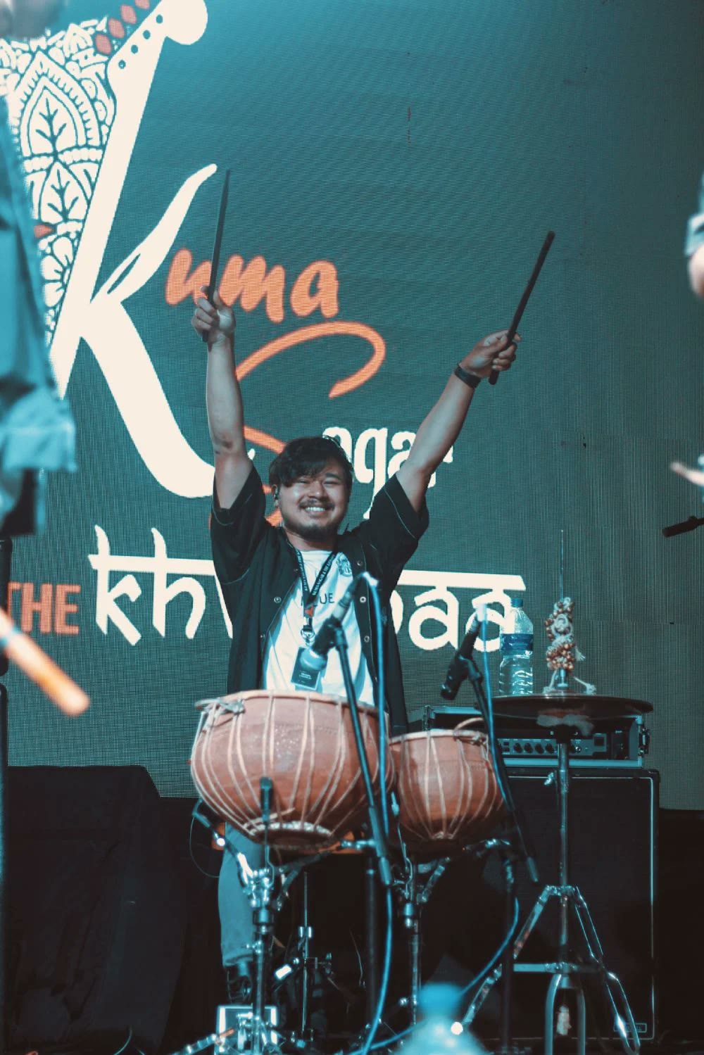 Kuma Sagar on stage with the Khwopa Band, madal in hand