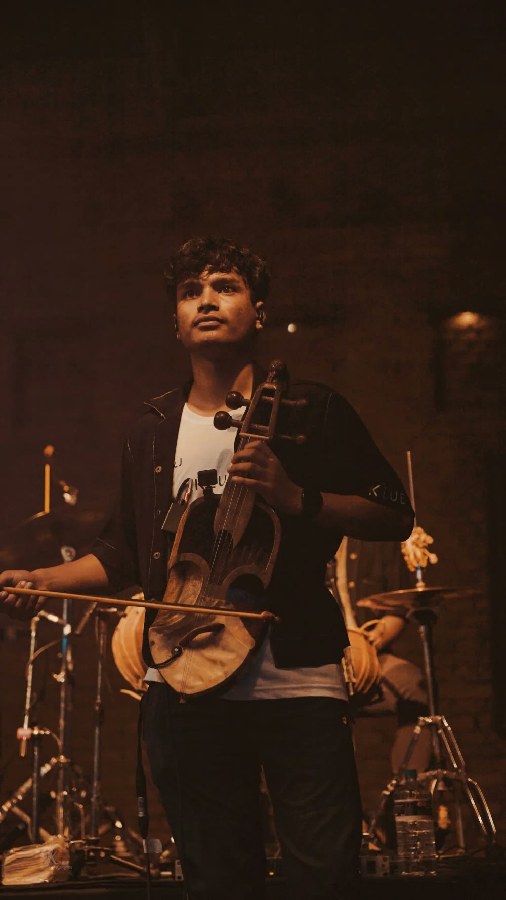 A Khwopa Band member playing the sarangi on stage
